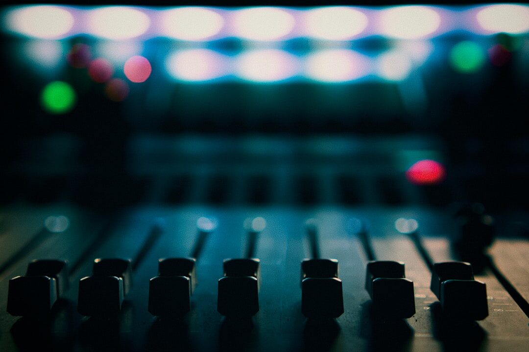 Close up of audio mixer knobs and faders