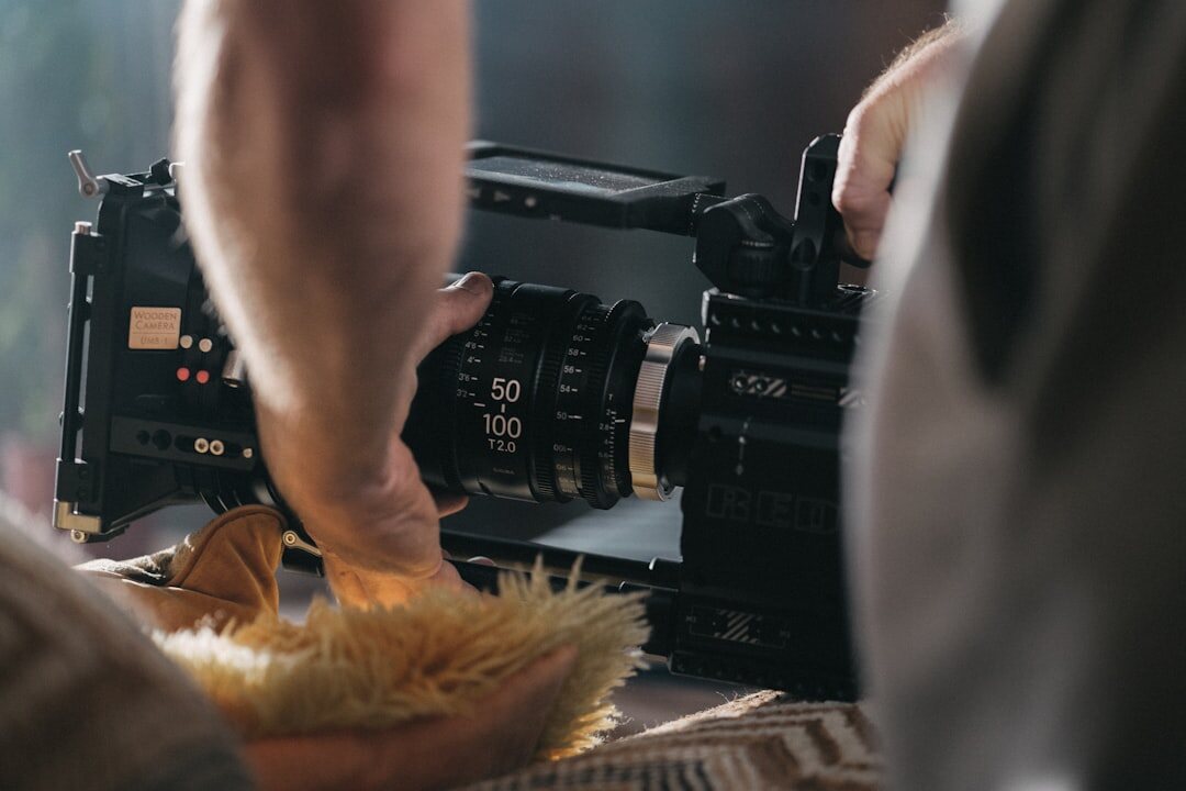 Hands operating a professional video camera