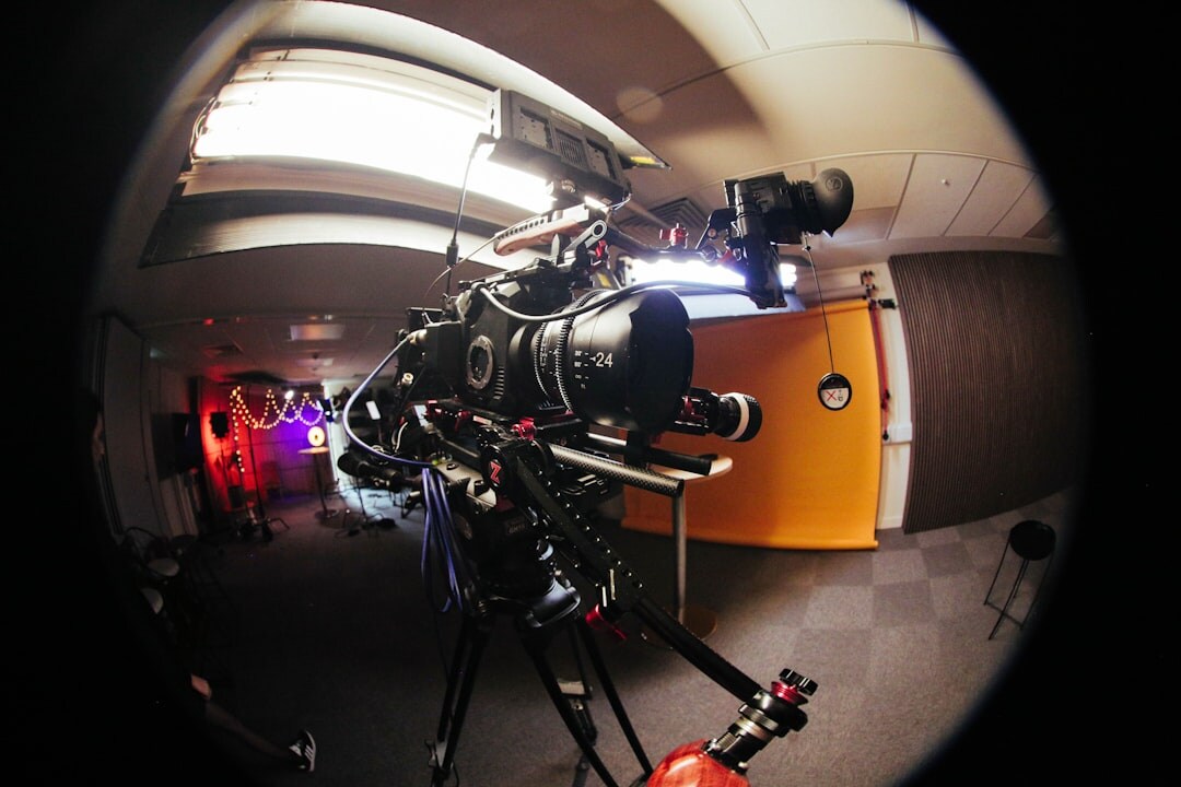 Video camera mounted on a tripod in a studio