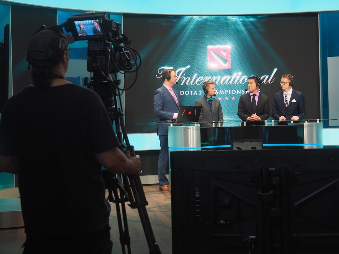 Television studio camera pointed at a news desk
